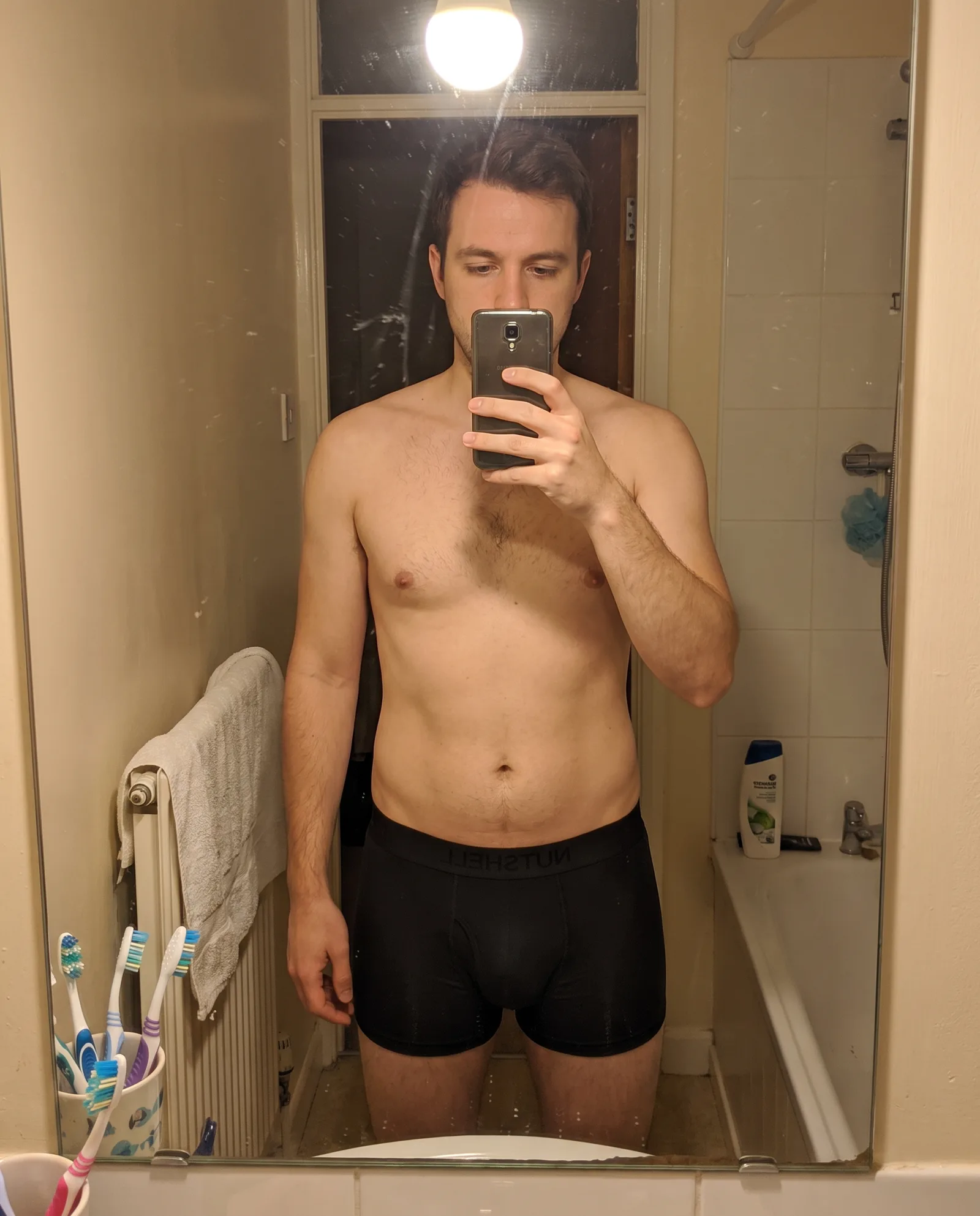 Man maakt een spiegelselfie in de badkamer